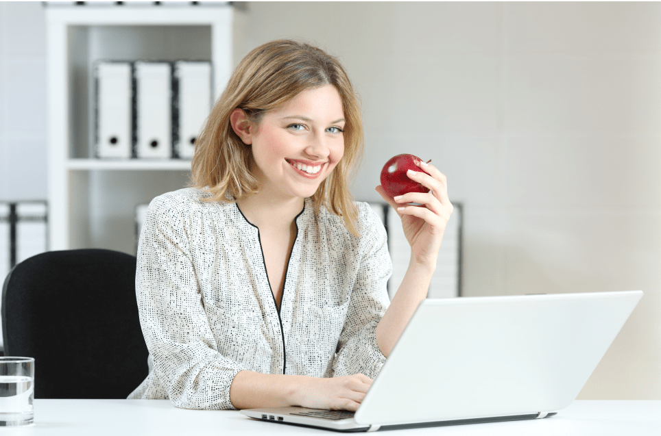 Photo of woman holding an apple for woolworths group case study